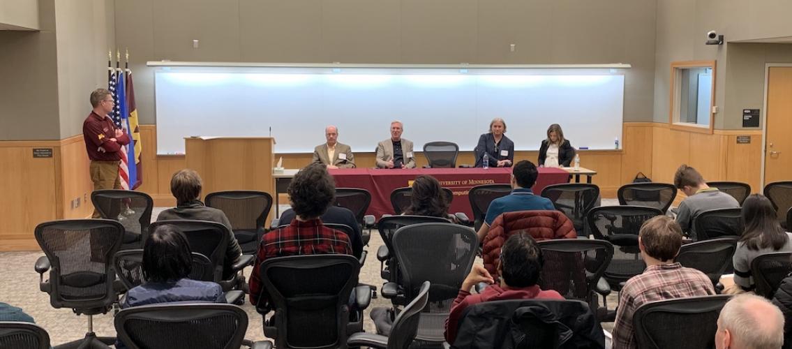 four panelists sitting at a table