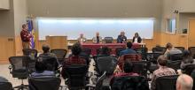 four panelists sitting at a table